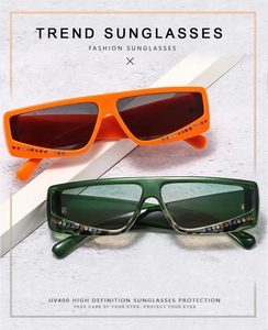 Detail of square rhinestone sunglasses with orange and green frames and UV400 protection