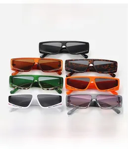 Detail view of colorful square sunglasses featuring rhinestone accents on rectangular frames