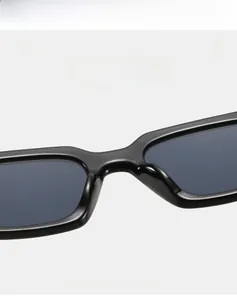Detailed macro shot of the premium glossy bridge and frame of the black square sunglasses