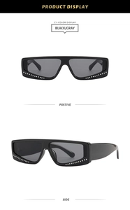 Detailed view of black square sunglasses with silver rhinestone trim on the frame