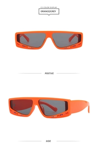 Detail of orange square rhinestone sunglasses featuring gray lenses and Y2K disco style