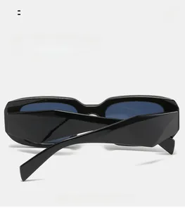 Detail view of thick black square frame sunglasses featuring curved mirror legs on white background