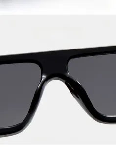 Detailed view of square black sunglasses showing the integrated bridge and premium frame