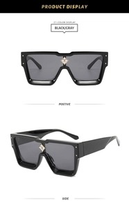 Detailed view of square sunglasses with gray lenses and star crystal nose bridge accent