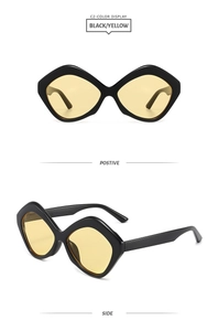Detail view of black geometric irregular sunglasses with transparent yellow lenses