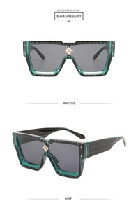 Detail view of oversized dark green marble sunglasses with floral silver nose bridge inlay