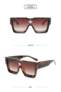 Detail of leopard print square sunglasses featuring a floral rhinestone center ornament