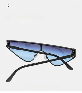Detail of curved mirror legs and gradient lenses on stylish cat-eye sunglasses