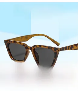 Close-up of stylish leopard print sunglasses with square dark lenses on 3D geometric base
