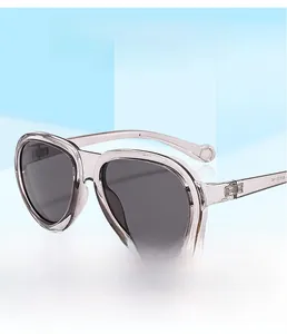 Detailed view of fashionable pink translucent oversized sunglasses with dark gray lenses