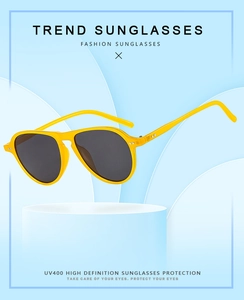 Detail of pilot sunglasses with yellow frame, UV400 grey lenses and rivet accents