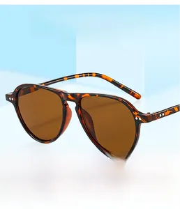 Macro shot of oversized tortoiseshell aviator sunglasses with retro metal hinge detail