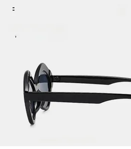 Side view detail of black oversized geometric sunglasses with wide thick temples
