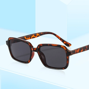 Classic tortoise shell square frame sunglasses with black lenses on blue platform
