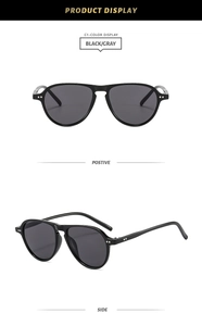 Close-up of black frame sunglasses with dark gray lenses and double dot metal rivets