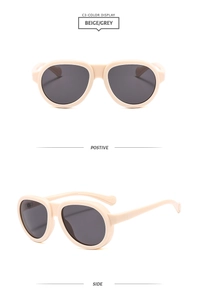 Front and side view of beige oversized sunglasses with grey lenses in a minimalist style
