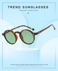 Detail of round tortoiseshell sunglasses with metal rivets and UV400 lenses