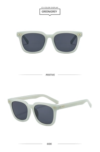 Detail view of green and grey square sunglasses with golden metal rivets on the frame