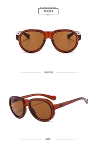 Detailed front and side views of tea-colored oversized pilot sunglasses with translucent frames