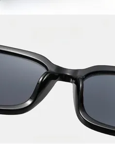 Detail of premium black square sunglasses frame showing smooth bridge and dark gray lenses
