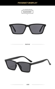 Detailed view of classic square black sunglasses with gray lenses and glossy finish