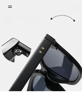 Detail of durable metal hinges and golden double studs on black glossy sunglasses