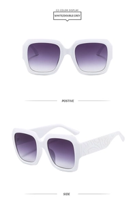 Vue détaillée des lunettes de soleil blanches avec motifs sculptés sur les branches