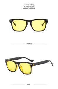 Detail view of retro square black frames with yellow lenses and silver arrow rivets