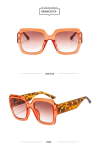 Détail de lunettes de soleil carrées orange avec verres dégradés et branches léopard