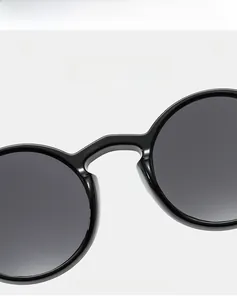 Detail of lightweight round black frame sunglasses showing high-elasticity flexible material
