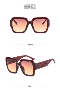 Détail de lunettes de soleil carrées rouges avec branches gravées et verres dégradés