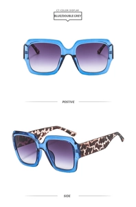 Détail des lunettes de soleil carrées bleues avec verres dégradés violets et branches léopard