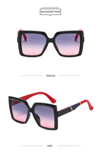 Detail of square black sunglasses with red temples and purple gradient lenses