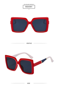 Detail view showing oversized red square frame sunglasses with off-white temples and stripes