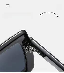 Close-up of durable metal hinge on stylish oversized black sunglasses with screw detail
