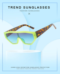 Detailed view of UV400 cycling sunglasses with neon yellow frame and gradient blue lenses