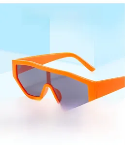 Close-up of orange frame UV400 cycling sunglasses with grey lenses on a blue stand