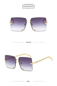 Detail of square rimless sunglasses with gold chain temples and grey gradient lenses
