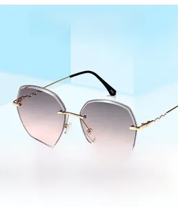 Macro shot of rimless sunglasses with gradient lenses and golden wavy metal temples