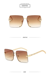 Detail view of square rimless sunglasses with gold chain temples and tea gradient lenses