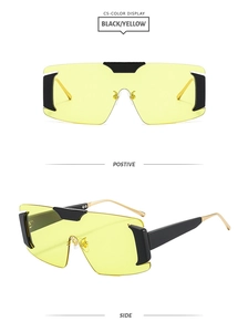 Detail view of yellow rimless oversized sunglasses with gold metal temples and black accents