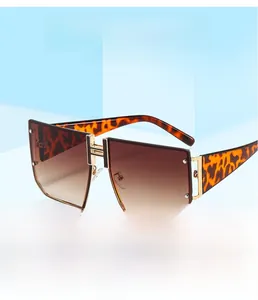 Close-up of tortoise shell sunglasses featuring gradient lenses and gold H-hinge detail