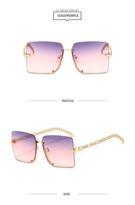 Detail view of gold purple gradient sunglasses with stylish metal chain arms and rimless frame
