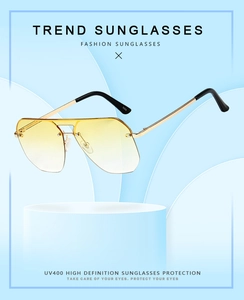 Detail of UV400 gradient lenses and gold metal double bridge on modern sunglasses