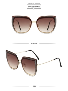 Dettaglio degli occhiali da sole cat-eye dorati con lenti sfumate marroni e glitter