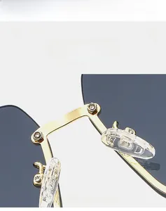 Detail of gold metal nose bridge and soft silicone pads on square half-frame sunglasses