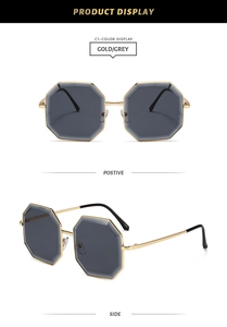 Detail view of octagon metal sunglasses with gold frames and dark grey lenses