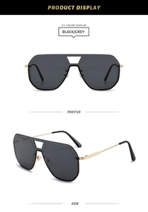 Détail de lunettes aviateur à double pont avec monture dorée et verres dégradés gris