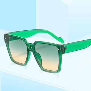 Lunettes de soleil carrées vertes translucides avec verres dégradés jaune-vert et clous dorés
