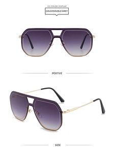 Détail de lunettes aviateur vintage avec verres dégradés violets et branches dorées